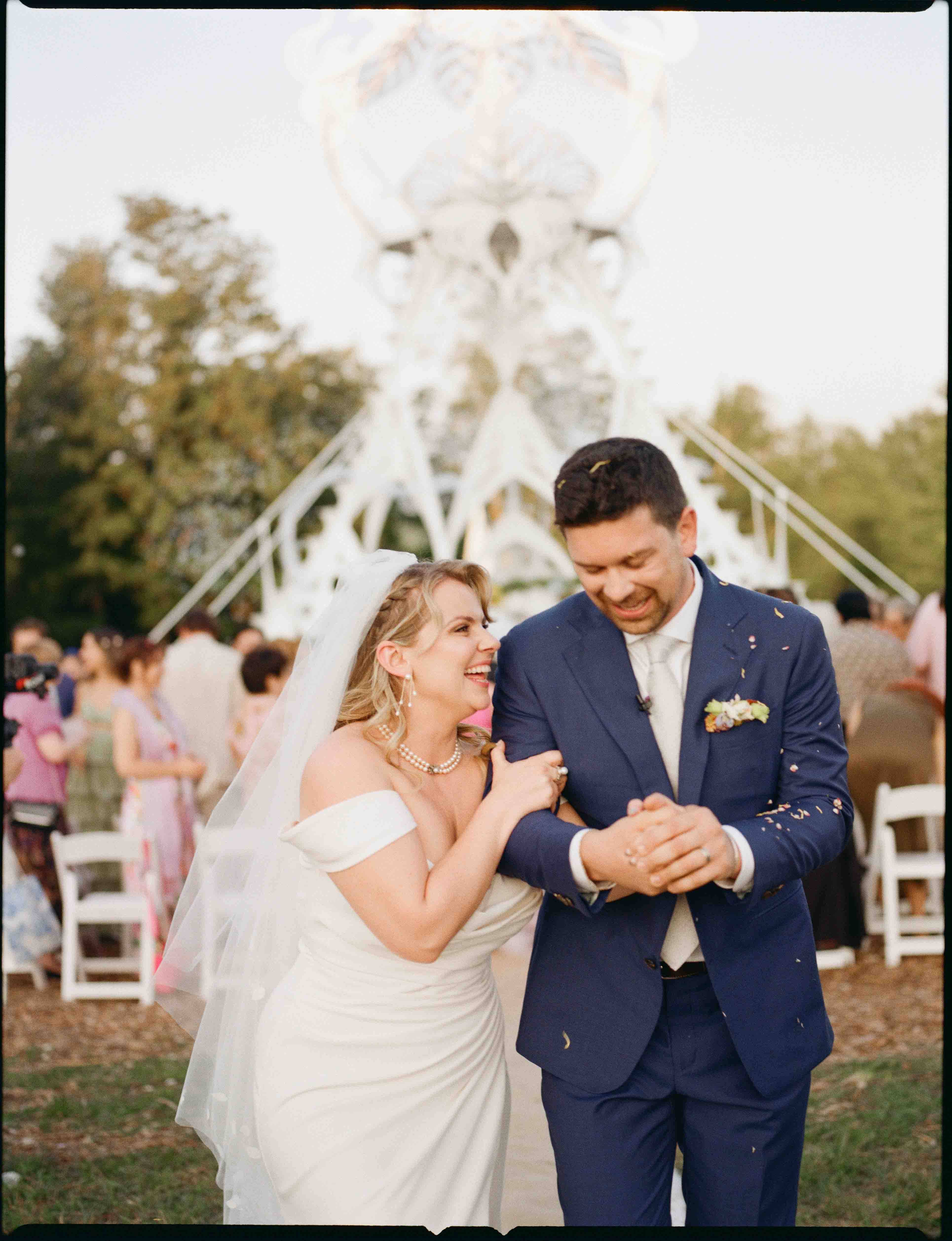 Photographer and videographer working together seamlessly at a wedding
